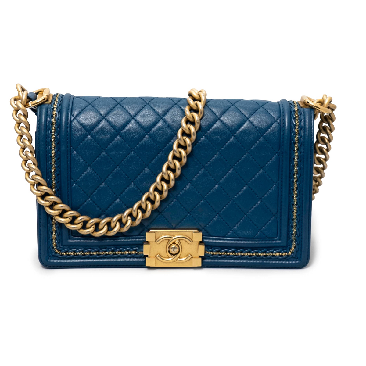 Blue quilted Chanel handbag with gold chain and clasp on a white background