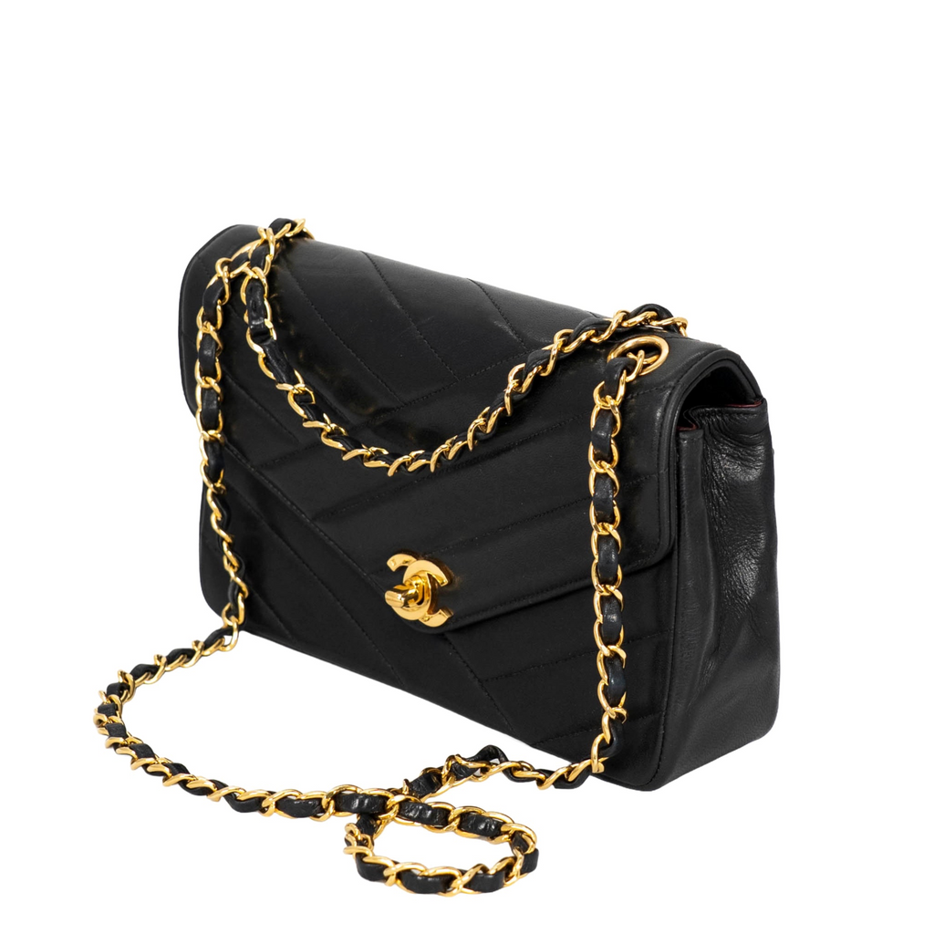 Your Bag Now Mine Chanel black chevron-quilted lambskin flap bag with gold-tone chain strap and CC turn-lock closure