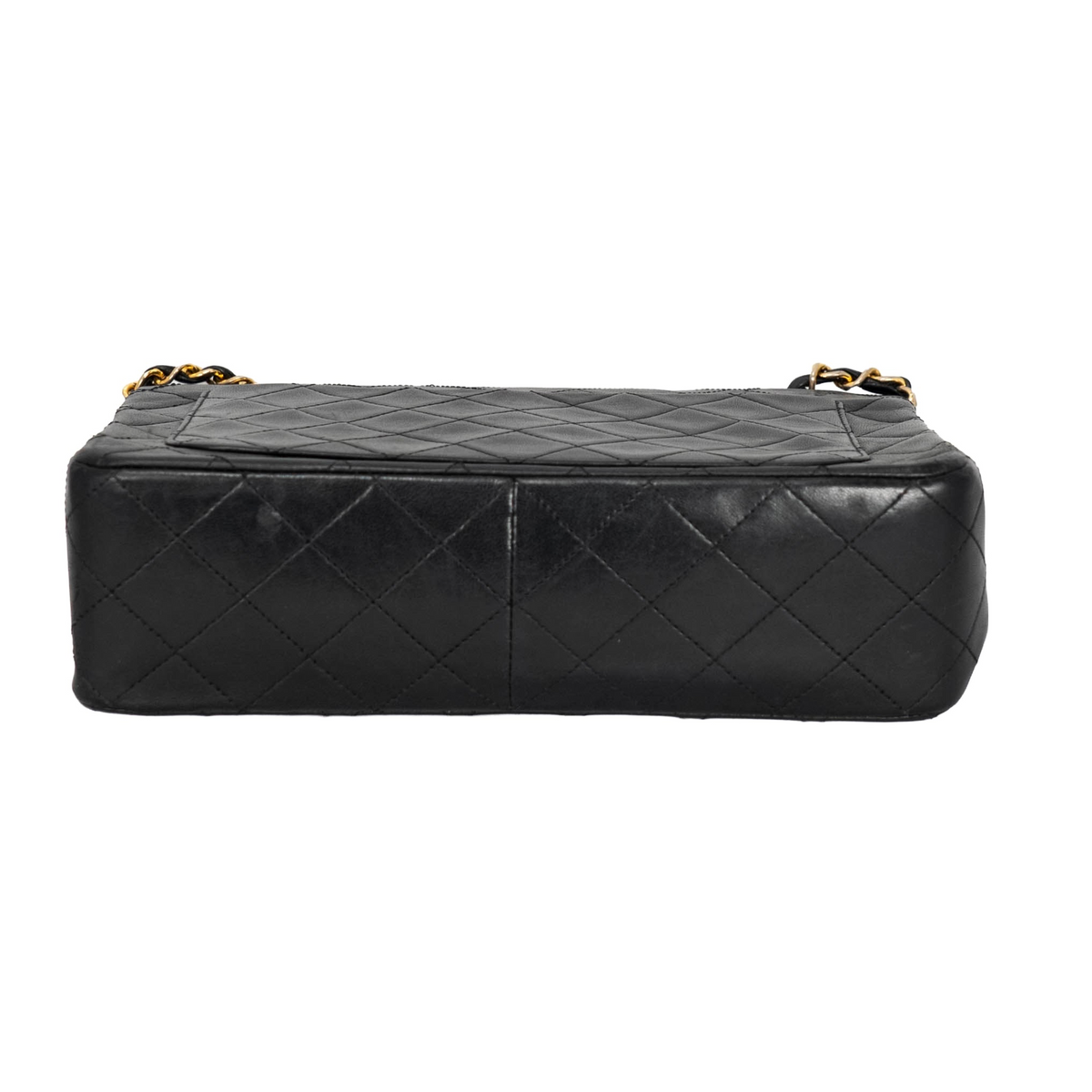 Your Bag Now Mine Chanel black quilted leather trapezoid bag bottom view showing diamond stitching and gold hardware