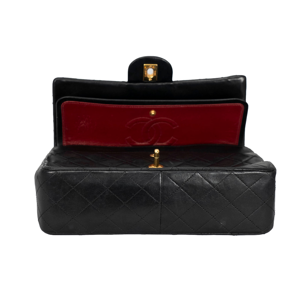 Your Bag Now Mine Chanel black quilted leather trapezoid bag with gold hardware and red interior flap detail