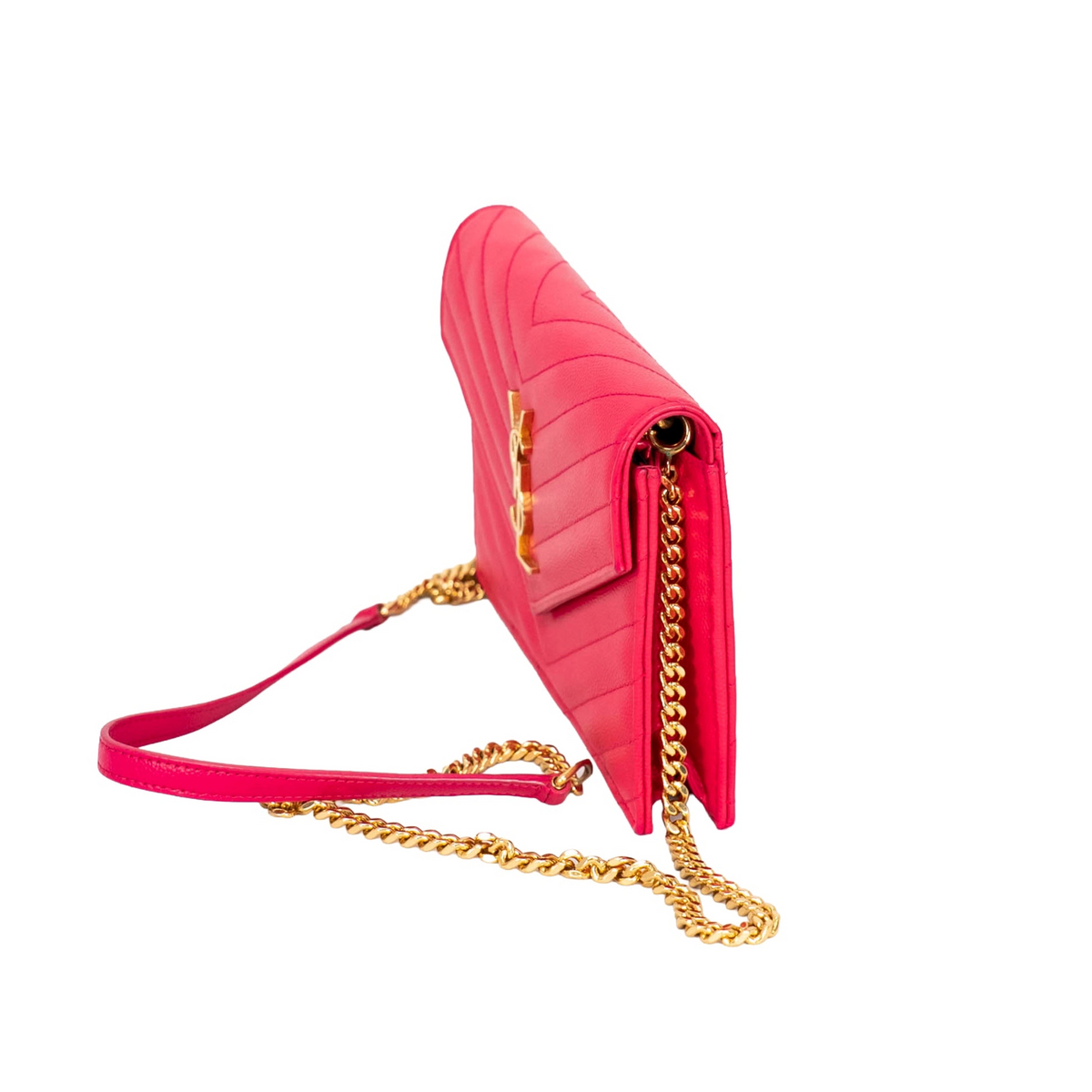 Side view of Yves Saint Laurent pink envelope handbag with gold YSL logo on V-shape front flap and gold strap.
