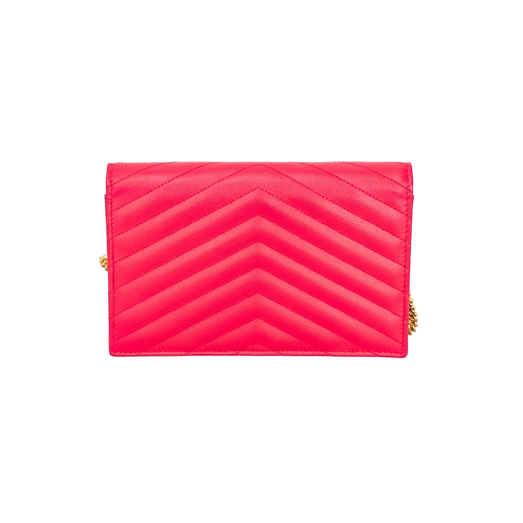 back view of Yves Saint Laurent pink envelope handbag with gold YSL logo on V-shape front flap and gold strap.