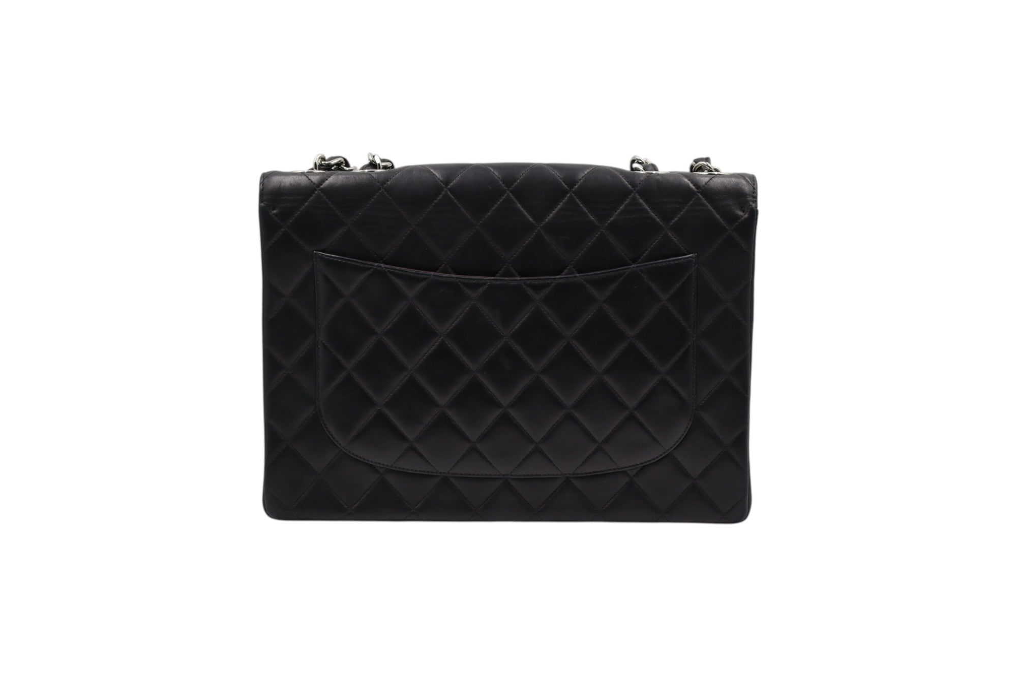back view Chanel black quilted leather clutch bag with silver-tone chain strap hardware, shown from the front on a plain white background.