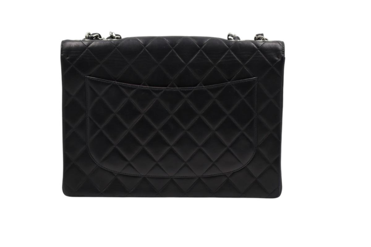 back view Chanel black quilted leather clutch bag with silver-tone chain strap hardware.