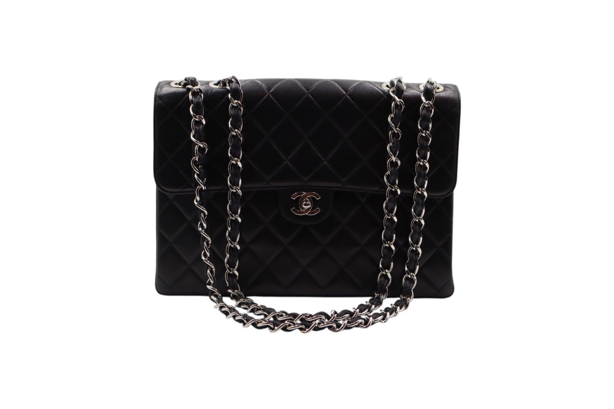 front view Chanel black quilted leather handbag with a silver-tone chain strap and a gold-tone interlocking CC logo on the front, set against a plain white background.