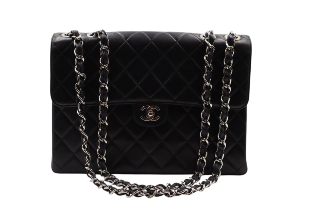 front view Chanel black quilted leather handbag with a silver-tone chain strap and a gold-tone interlocking CC logo on the front.