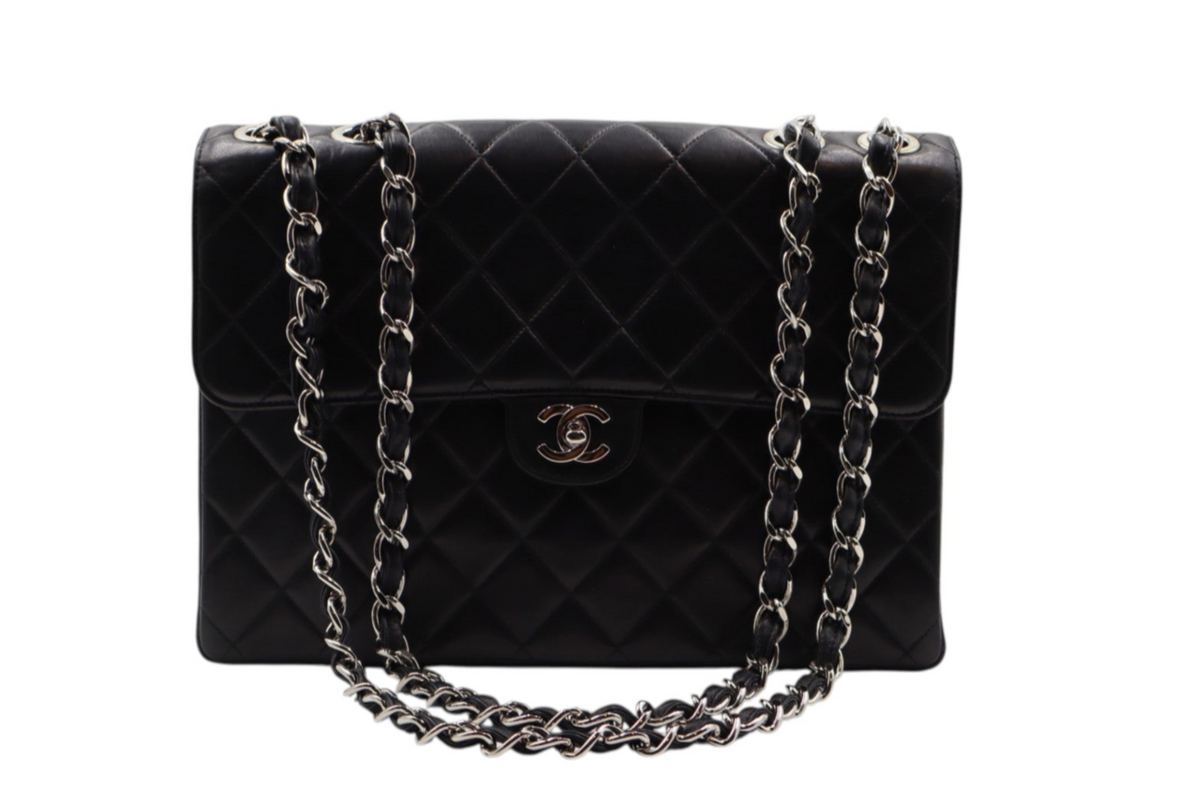front view Chanel black quilted leather handbag with a silver-tone chain strap and a gold-tone interlocking CC logo on the front.