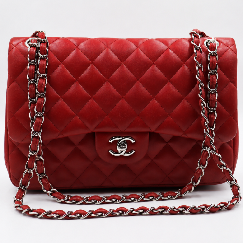 front view Chanel red quilted leather shoulder bag with a silver-tone chain strap and a silver interlocking CC logo on the front, set against a white studio background.