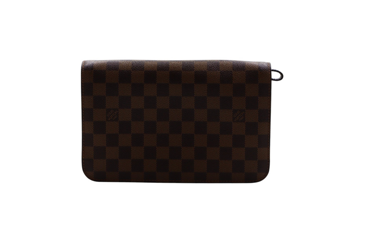 back view of a Louis Vuitton brown and black checkered clutch bag with a small black ring detail on the right side.
