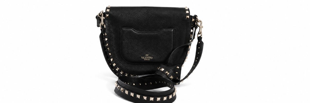 Back view of a Valentino black leather shoulder bag with gold-tone studs and a matching studded strap, shown against a plain white background.