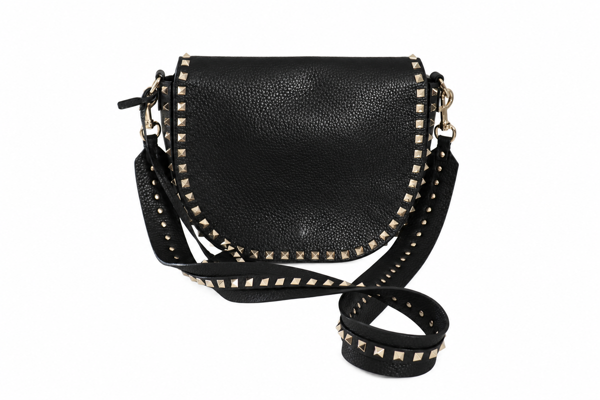 A Valentino black pebbled leather crossbody bag with gold-tone studs and hardware, shown on a plain white background.
