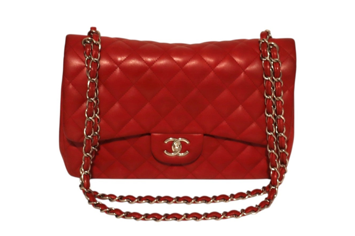 A red quilted Chanel leather shoulder bag with a gold-tone interlocking CC logo on the front flap.