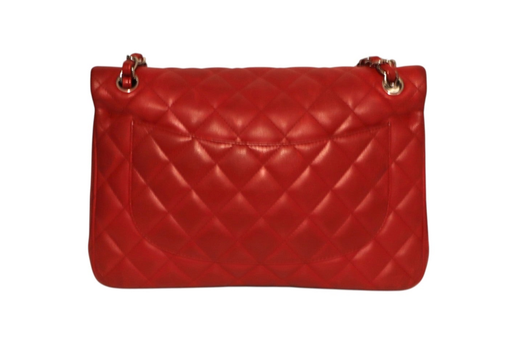 Back view of a red quilted Chanel leather shoulder bag with gold-tone chain strap attachments.