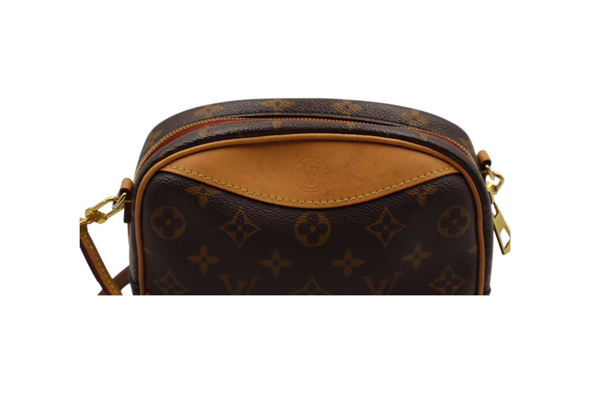 close up of backview Louis Vuitton monogram canvas crossbody bag with tan leather trim and gold-tone hardware, shown against a plain white background. shows slight discoloration on the tan leather.
