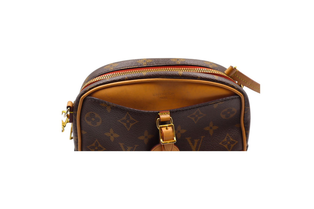 close up front view of Louis Vuitton monogram canvas pouch with tan leather trim and gold-tone hardware, shown against a plain white background. shows slight discoloration on tan leather.