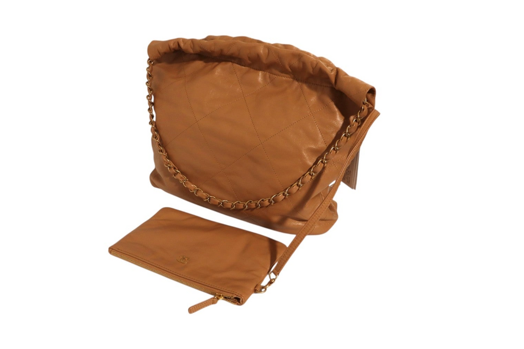 Back view of Chanel tan quilted leather shoulder bag with ruched top, gold-tone chain strap, and matching leather zip pouch with wrist strap displayed