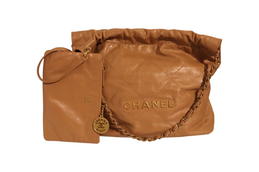 Front view of Chanel tan quilted leather shoulder bag with gold-tone CHANEL lettering, chain strap, ruched top, and matching leather pouch with wrist strap