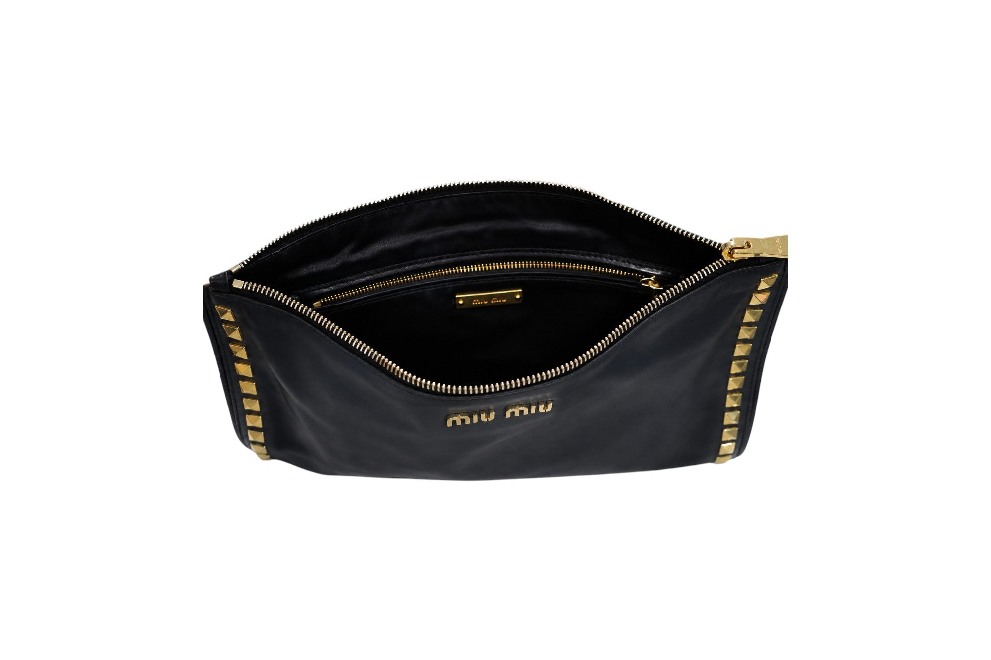 A black Miu Miu nylon pouch bag shown open, featuring gold-tone hardware, a gold zipper, and gold studs along the edges, with the 'miu miu' logo printed in gold on the front.