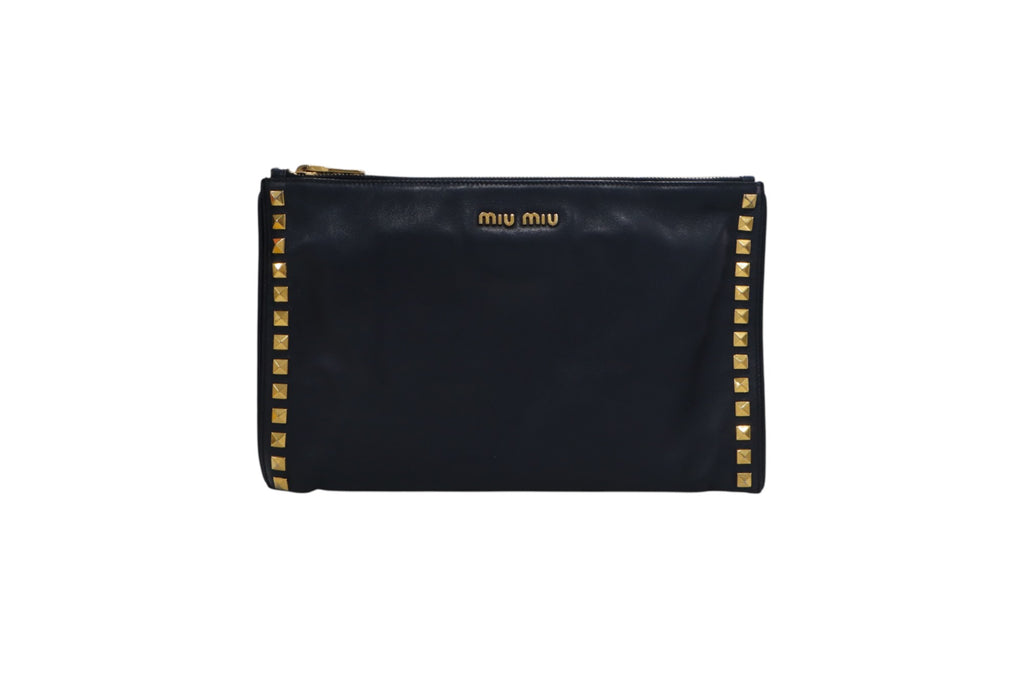 front view black leather Miu Miu zip-around pouch with gold-tone studs along the edges and a gold logo on the front, set against a plain white background.