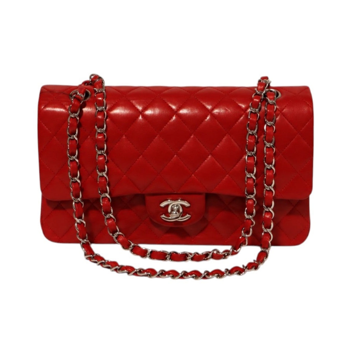 A Chanel red quilted leather handbag with a silver-tone interwoven chain strap and a silver interlocking CC logo on the front flap.