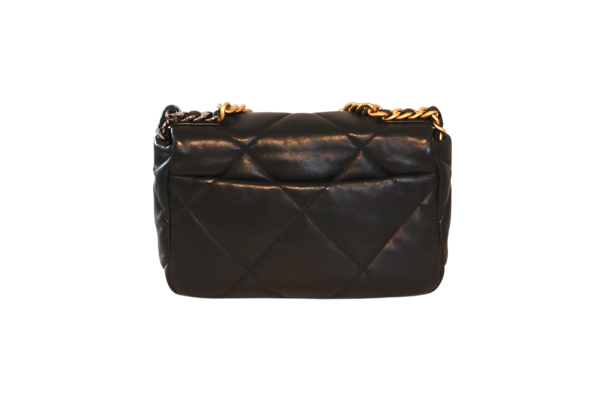 A black quilted leather Chanel flap bag with a gold chain strap.